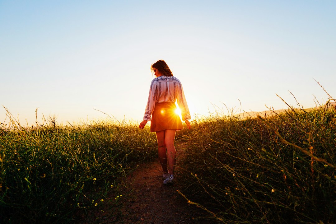 A person walking outdoors, illustrating energy, recovery, and whole-person wellness.