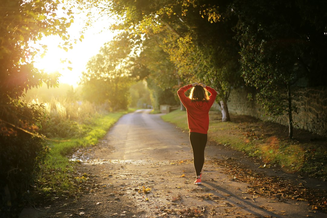 Person jogging outdoors, representing energy, movement and wellness.