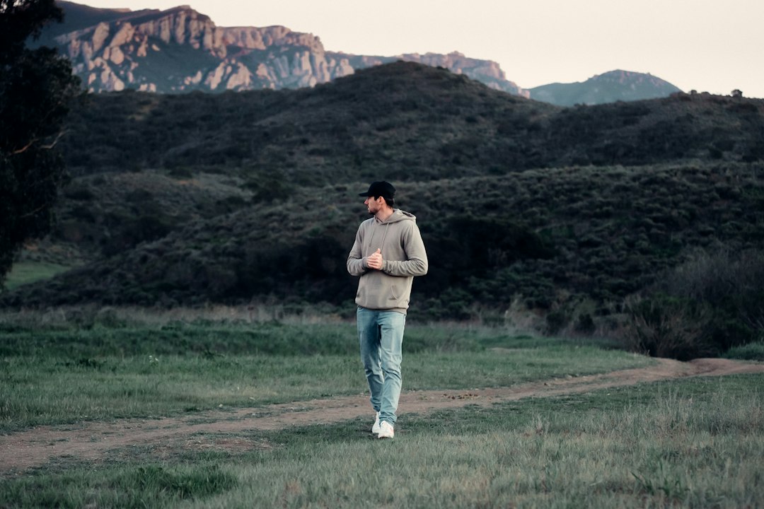 Person walking outdoors at sunset, representing movement, recovery, and everyday energy.
